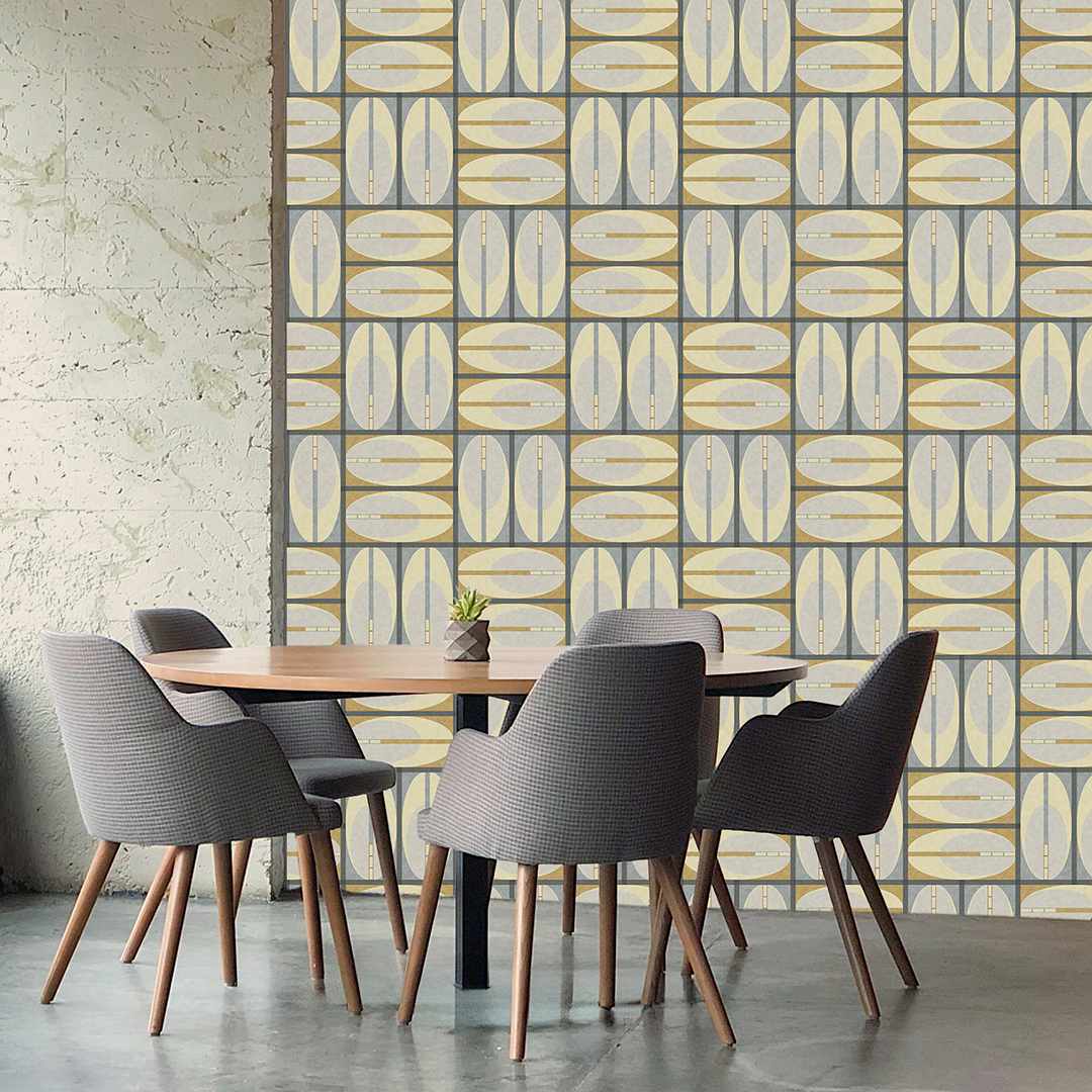 The artwork features a repeating geometric pattern of symmetrical shapes resembling elongated, curved diamonds or petals in various shades of blue and green. Each shape is split vertically with one half filled with a light blue and the other half filled with green or darker blue. The background is a light, almost pastel blue, which provides a soft yet vibrant backdrop. One of the blue shapes near the upper left contains a white starburst element, adding a focal point of brightness to the composition. The overall design conveys a modern, mid-century aesthetic with clean lines and harmonious color contrasts.